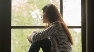 Depressed Or Traumatised Woman Staring Out Of The Window