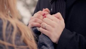 A Couple Holding Hands Tightly