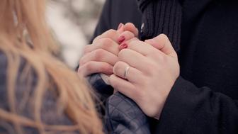 A Couple Holding Hands Tightly