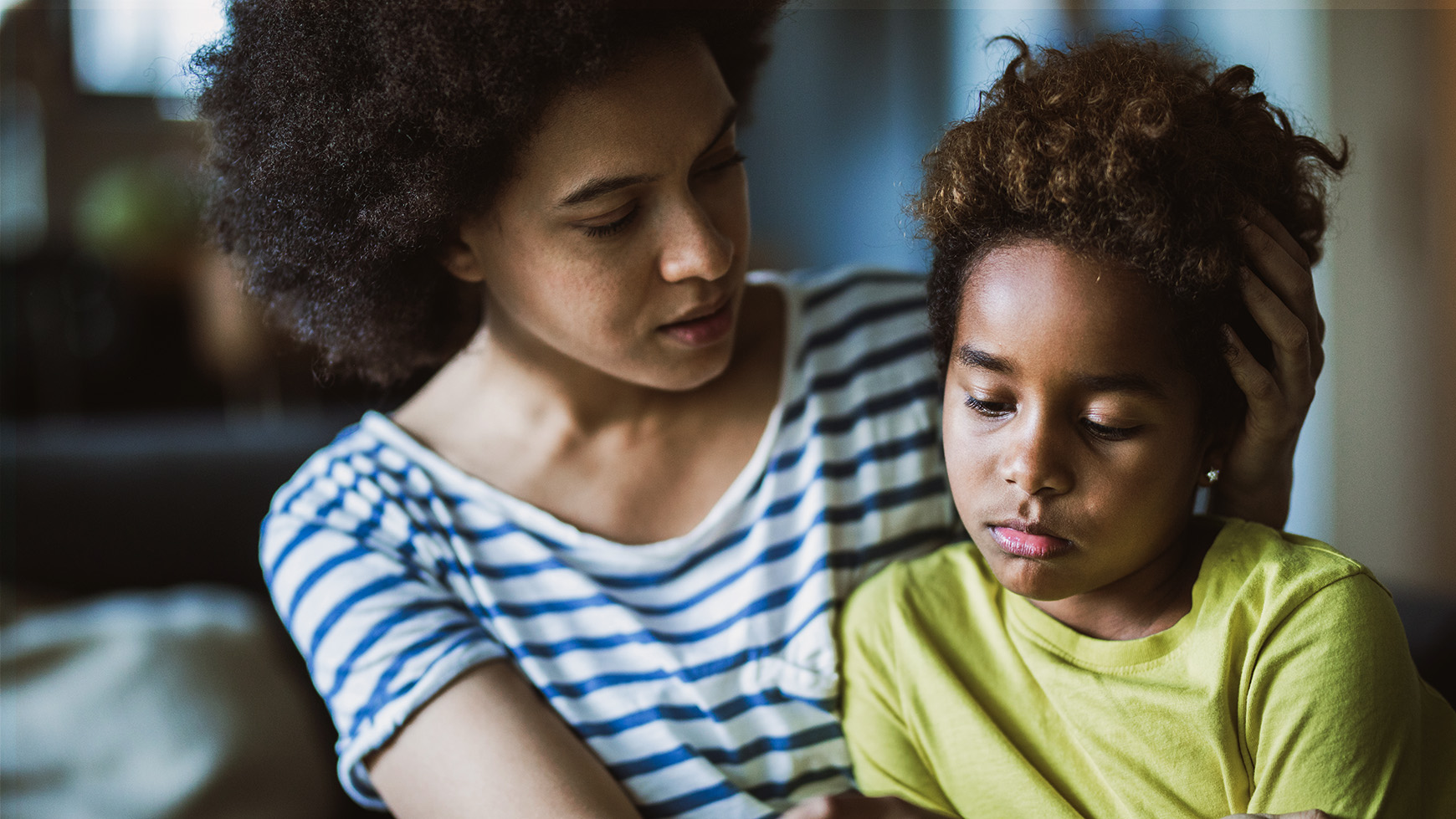 Mother Comforts Her Young Child By Stroking Their Hair