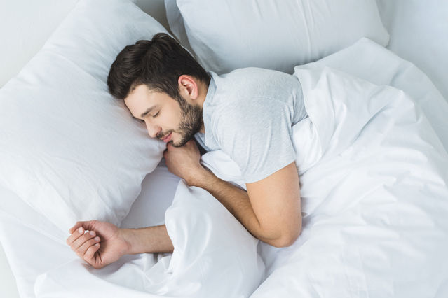 Man Getting A Good Night’s Sleep In Bed Man Getting A Good Night's Sleep In Bed