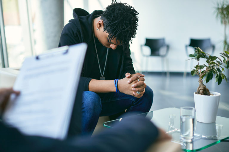 Sad Teenager Looking Down While Having A Counselling Session