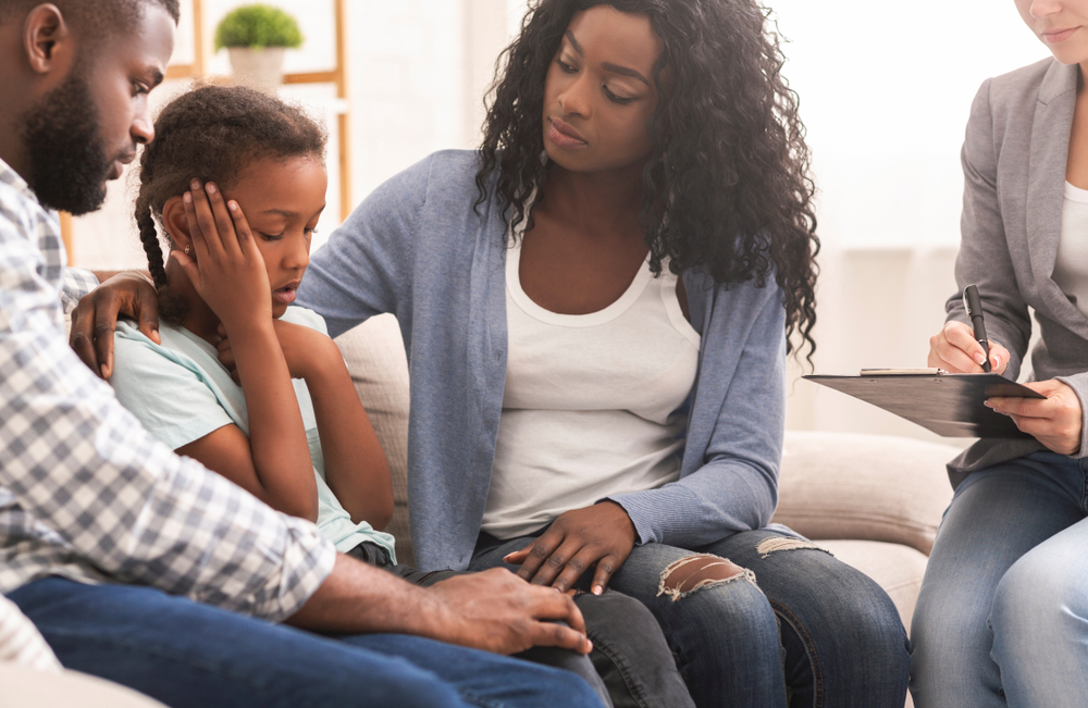 parents comforting child during child counselling session