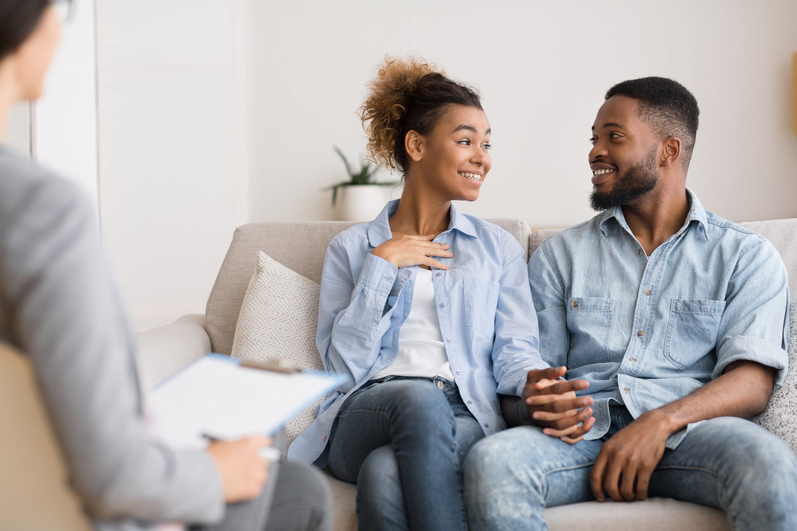 couple sat holding hands during couples therapy session