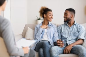 couple sat holding hands during couples therapy session