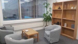 chairs and bookcase inside therapy room