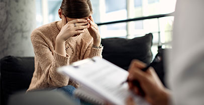 woman with head in hands during counselling session