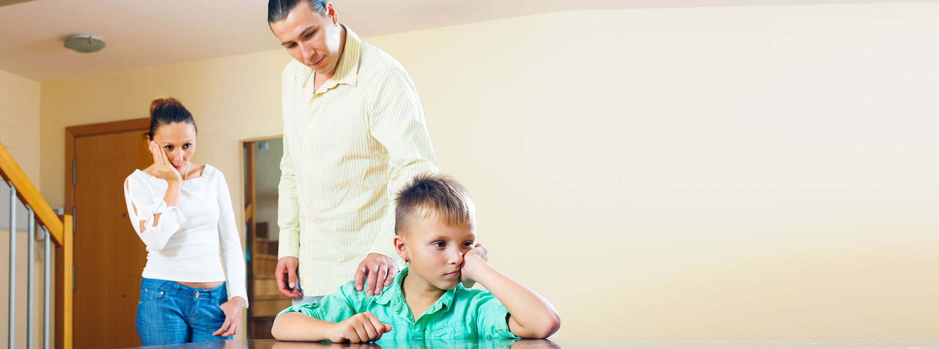 Parents talking to child who is looking away