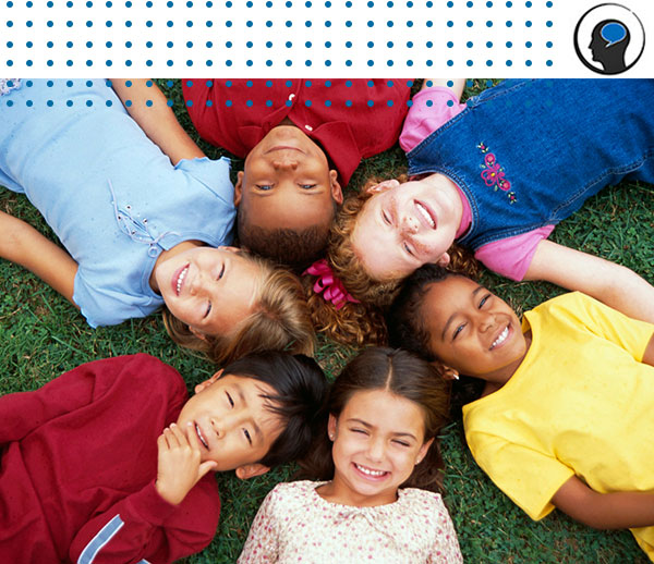 Smiling children lying down in a circle