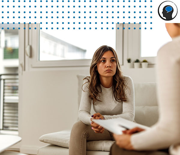 Woman sitting on couch and looking at therapist