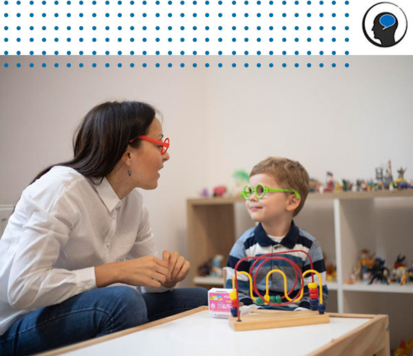 Child therapist playing with child during play therapy session