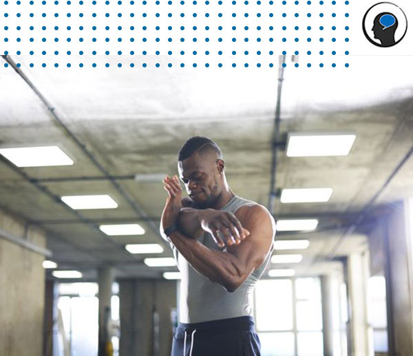 Man flexing muscles in gym