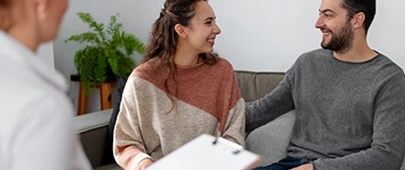 Couple smiling at each other during couples therapy session